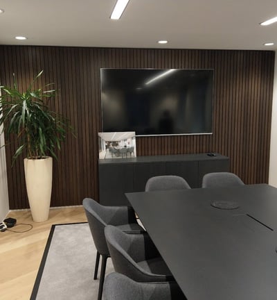 Large TV mounted on a wall in a boardroom