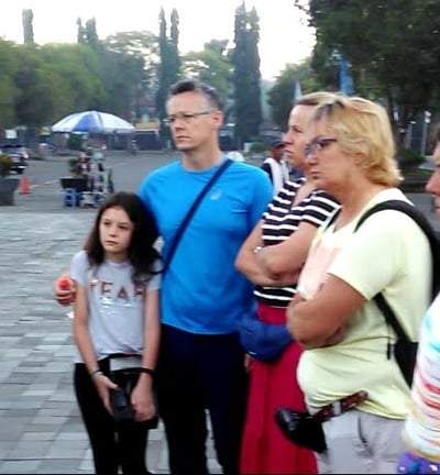 a group of people standing in brief around a group of european client