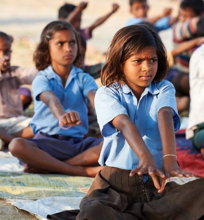 a group of children doing yoga in yoga campaign