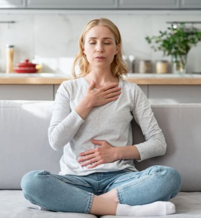 woman doing deep breathing exercise