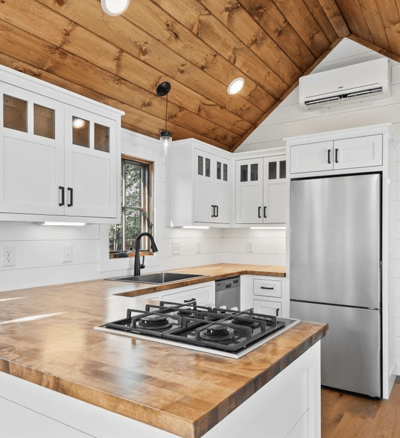 Modern kitchen in tiny home on wheels with wood accents