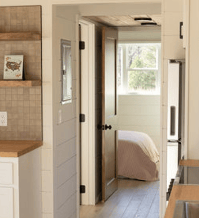 Cozy bedroom view inside bright tiny home on wheels