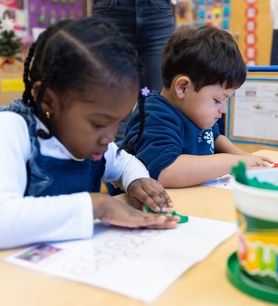 PreK students using playdough mats to develop fine motor skills.