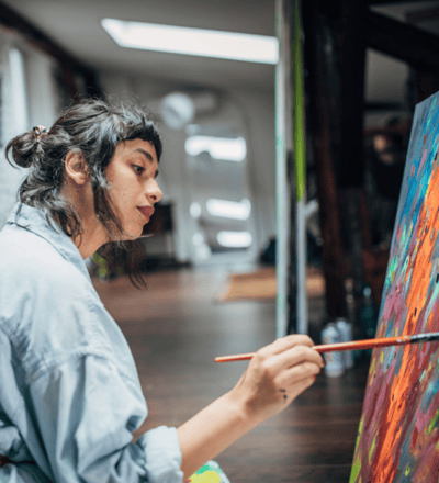 A female artist working on a painting