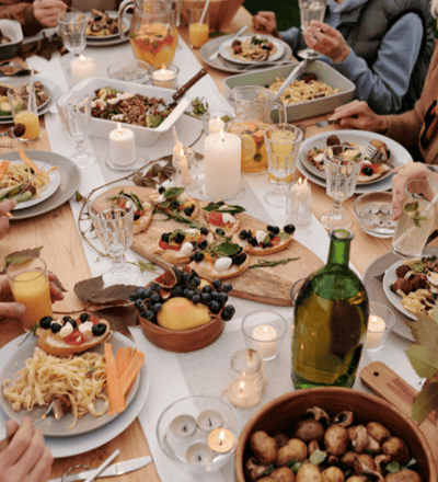 A group dinner with the image focused mostly on the plates of food