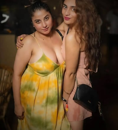 two women standing next to each other in a room