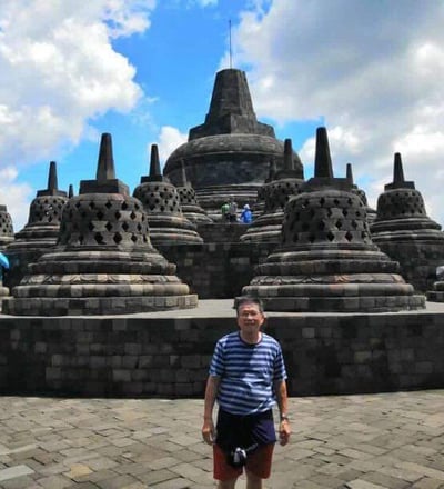 Majestic Borobudur Temple with its intricate stone carvings and bell-shaped stupas.
