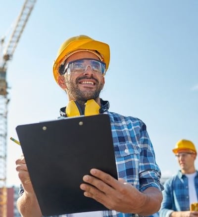 a man in a hard hat and safety vest