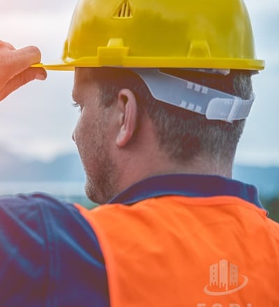 a man in a hard hat and safety vest