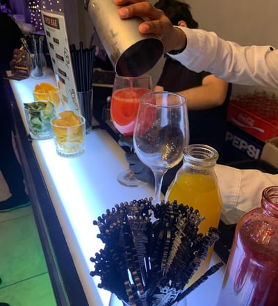 a bartender is pouring a drink at a bar