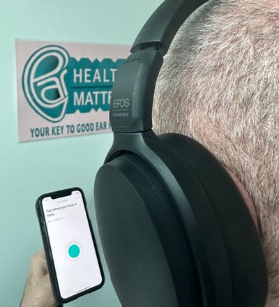 A man doing an online hearing test