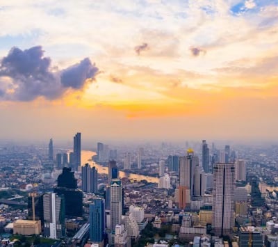 a cityscape of a city at sunset