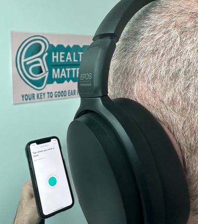 A man doing an online hearing test