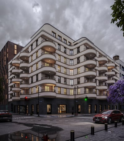 a building with a lot of windows and a car parked in front of it