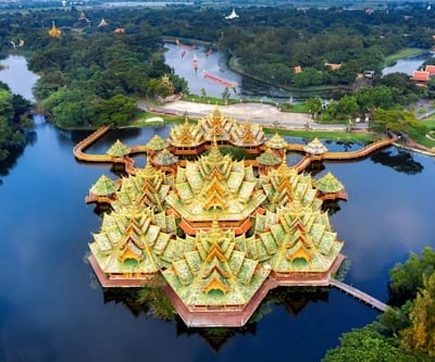 a large building with a large amount of green trees