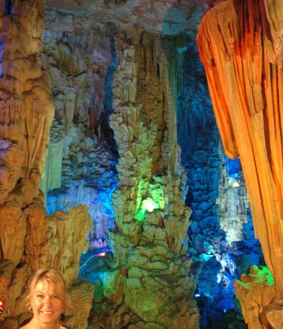 Tracey Billington at the colourful Reed Flute Caves, Guilin, China