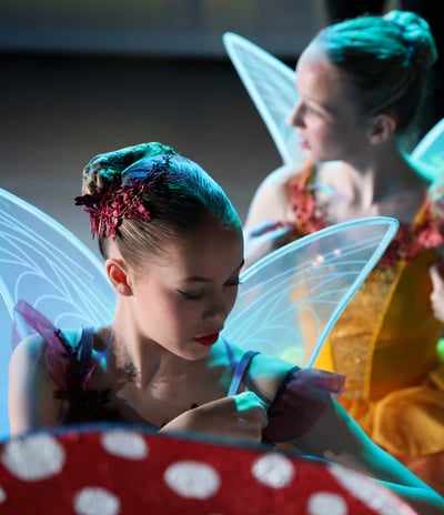 a group of young dancers dressed in fairy themed costumes