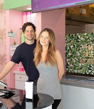 a man and woman standing in front of a counter
