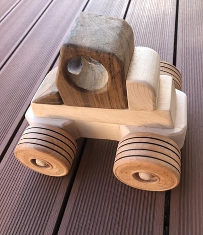 a wooden toy truck with a wooden toy car