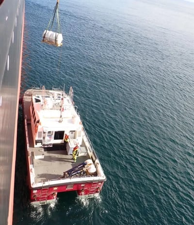 a boat with a crane on it's side and a crane on the side