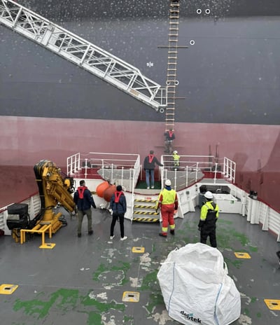 a large ship with a crane on the deck