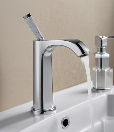 A close-up view of a row of brass water taps mounted on a white tiled wall. The foreground focuses on one tap, while more taps appear blurred in the background, creating a sense of depth.