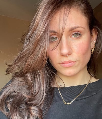 a woman with long hair and a necklace