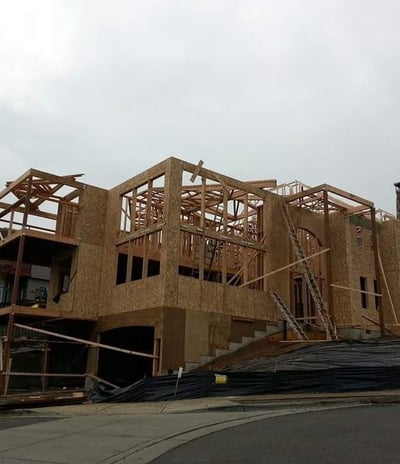 a house being built on a hill with a lot of wood framing
