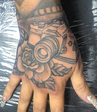 a person's hand with a camera on it