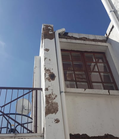 Weather-Exposed External Wall with Moisture and Plaster Erosion