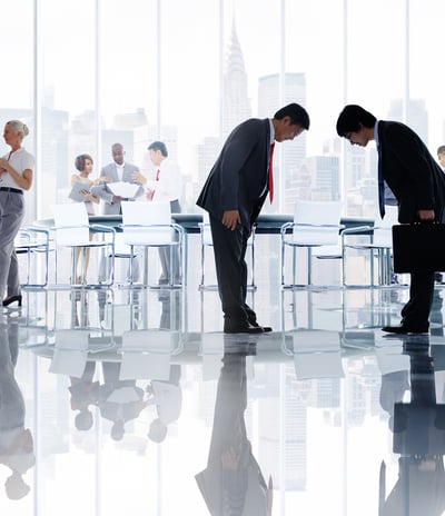 a group of business people standing in a conference room