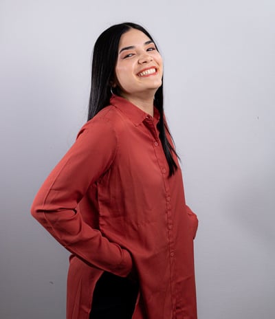 a woman in a red shirt and black pants