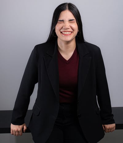 a woman in a black suit and red shirt