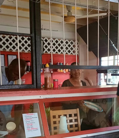 Owners of K.B. BABI restaurant inside their warm and inviting dinning space, offering a friendly atmosphere.