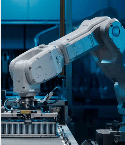 A robotic arm in a food packaging facility, positioned over a conveyor belt.