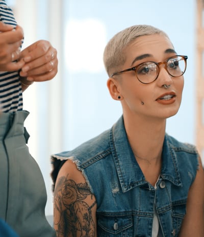 young tattooed woman in creative business meeting