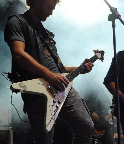 a man playing guitar in a concert