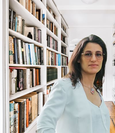 a woman in a white shirt and glasses in a library