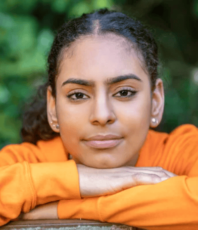 a woman with a bright orange shirt and a black shirt