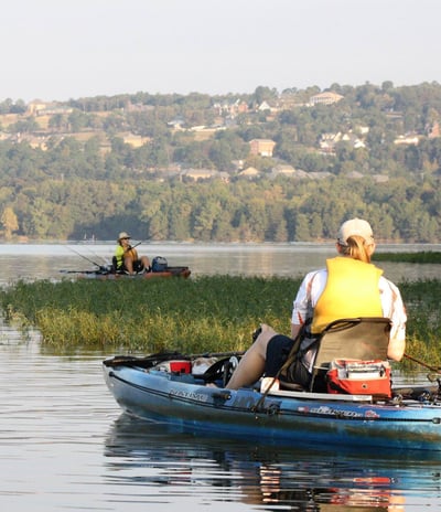 two people in a life jacket is sitting in a boat