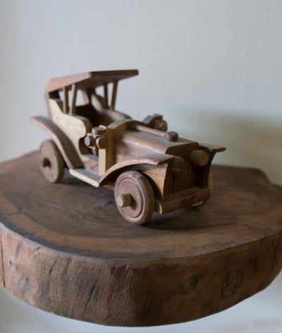 a wooden toy car on a wooden table the one bali art in lovina at sunrise lodge and lounge