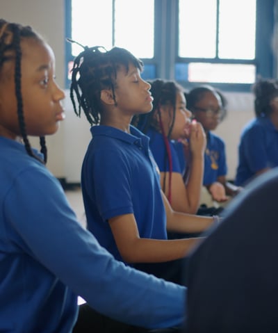 Students practicing deep breathing.