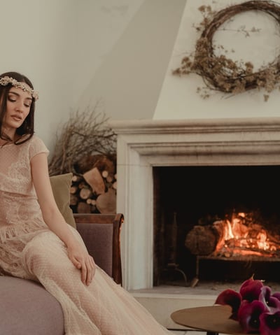 a woman in a long dress sitting on a couch