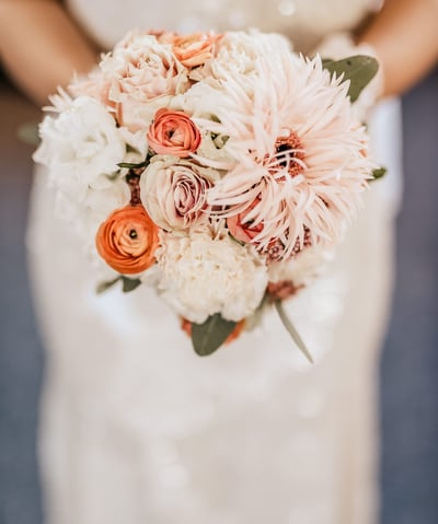 a bridesmael holding a bouquet of flowers