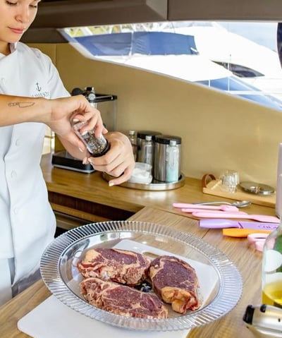 a woman in a white shirt is preparing to cook