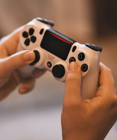 a person holding a game controller in their hands