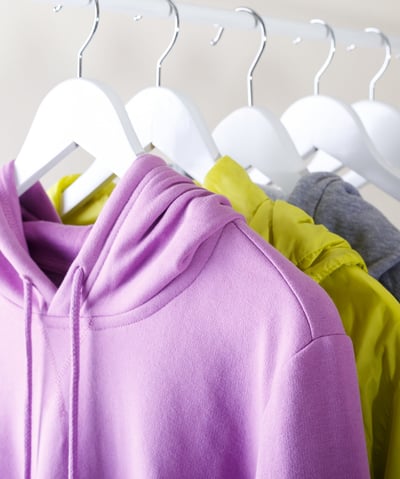 a bunch of clothes hanging on a rack