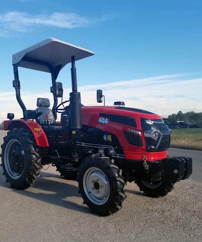 a red tractor with a canopy over it