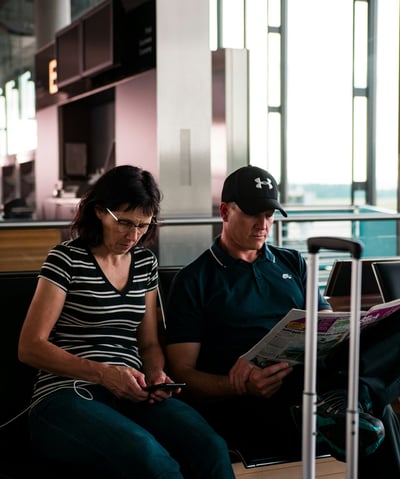 Women looking at phone in airport