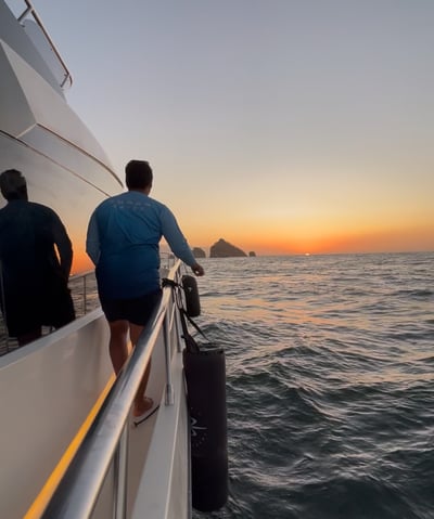 a man standing on a boat in the ocean